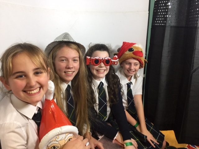 Photograph of pupils in photo booth at PSC Christmas Fayre